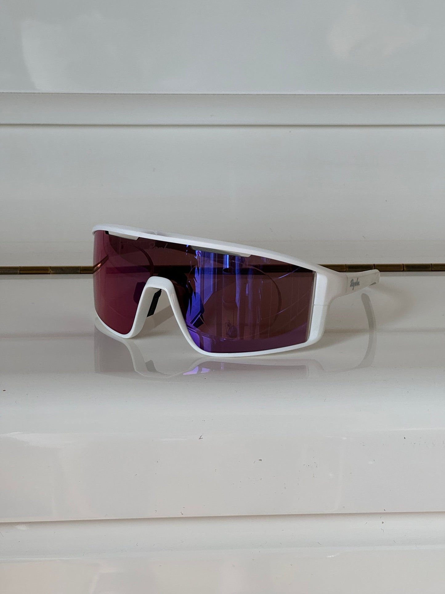 Cycling sunglasses with prescription insert installed, inside view showing pink lens