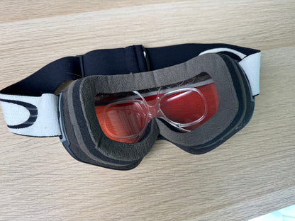 Oakley Flight Tracker ski goggle from face side showing prescription insert installed, red lens