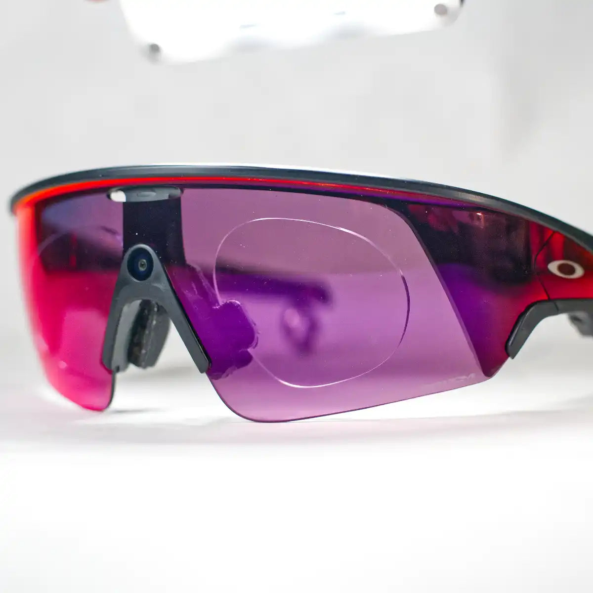 Oakley Meta Vanguard prescription insert, black-red frame, purple Prizm Road lens, angled view