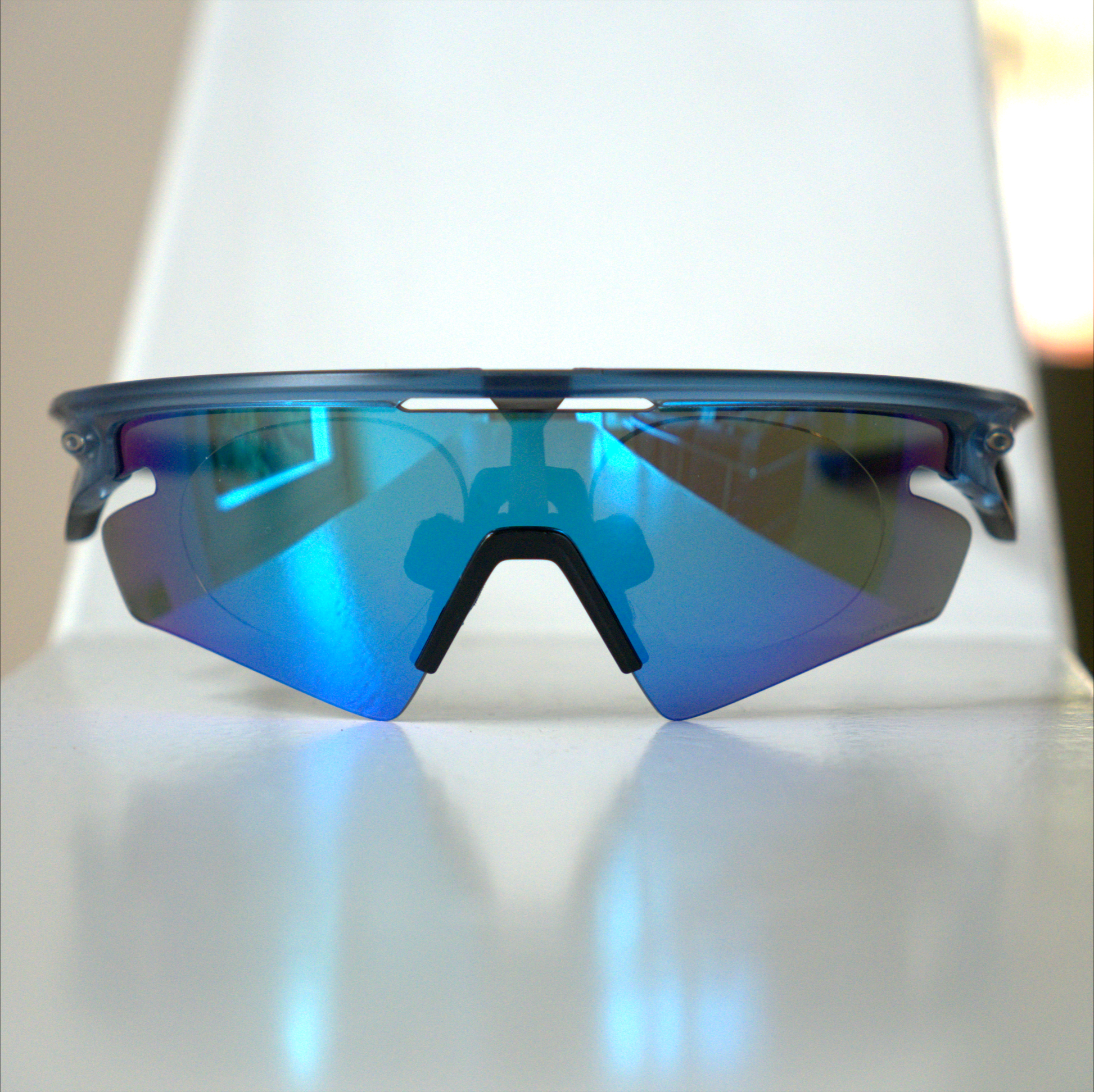 Oakley Sphaera with prescription insert installed, translucent blue frame with blue Prizm lens, front view