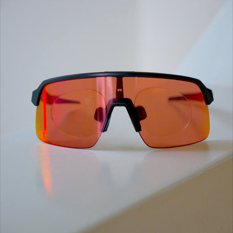 Oakley Sutro Lite prescription insert front view, black frame with red Prizm Road lens