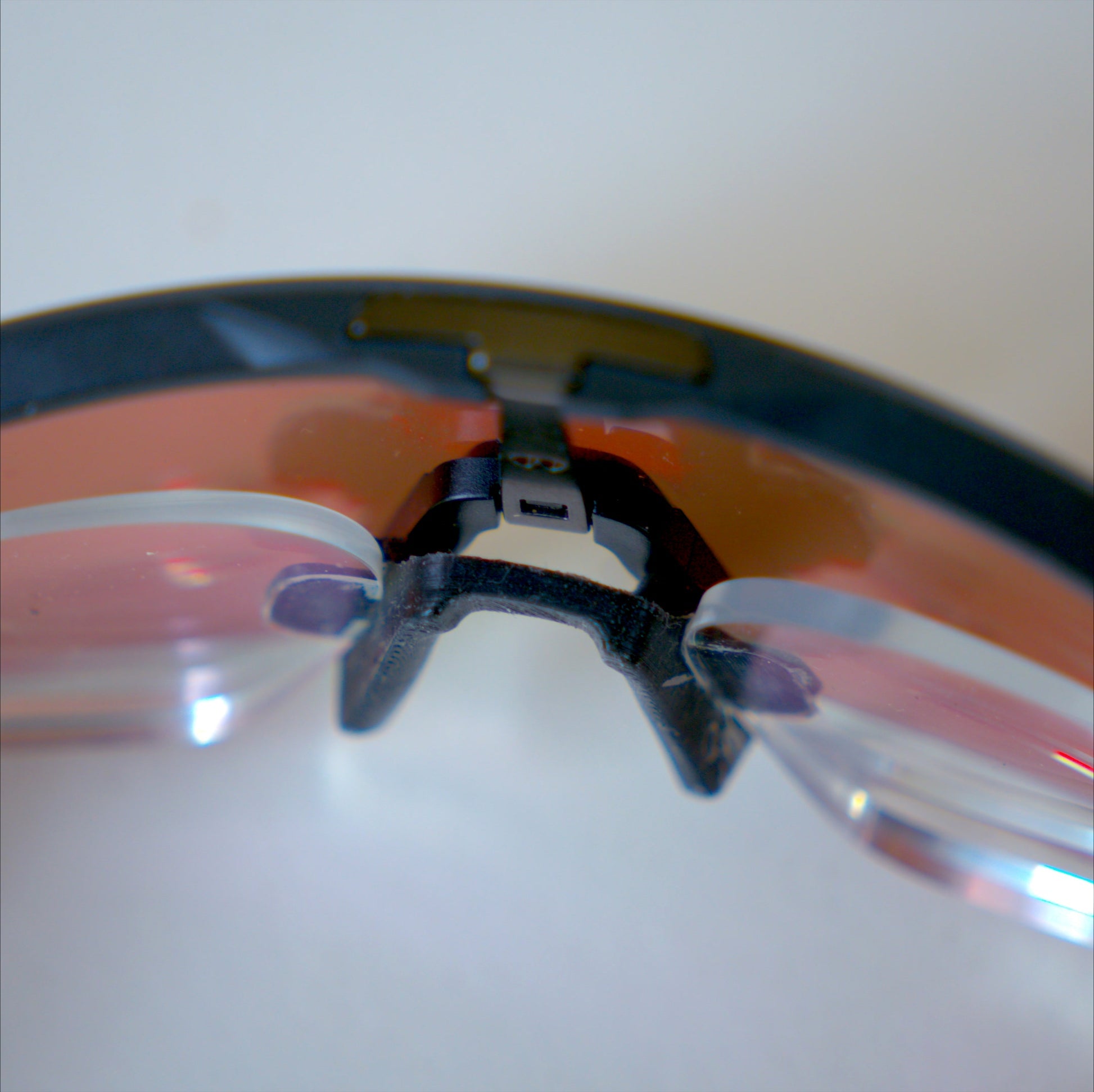 Top-down interior view of Oakley Sutro Lite prescription insert clip and nosepiece bracket