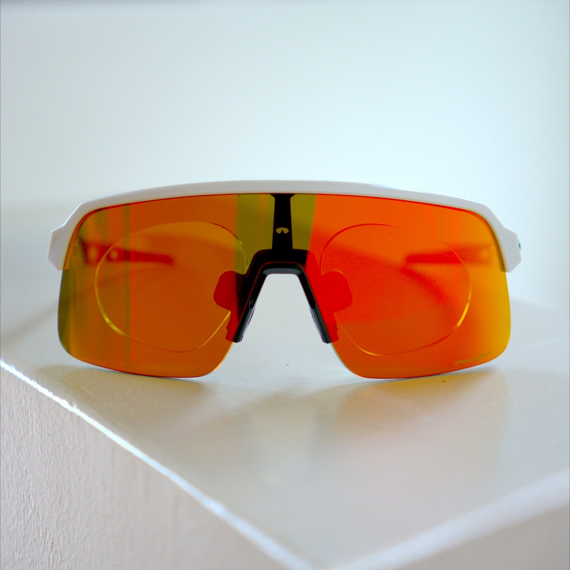 Oakley Sutro Lite S with prescription insert, white frame, orange-red Prizm lens, close front view