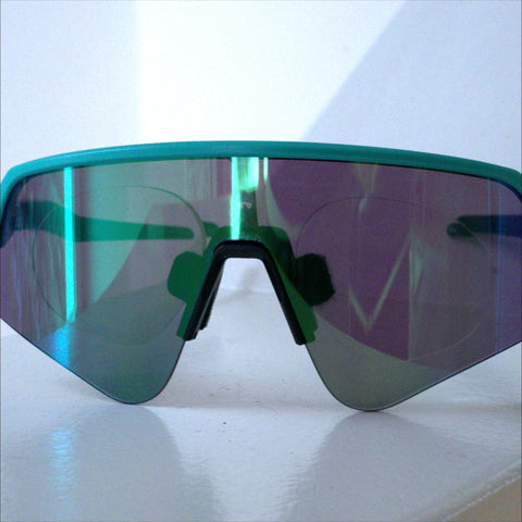 Oakley Sutro Lite Sweep prescription insert front view, teal frame with teal-purple mirrored lens