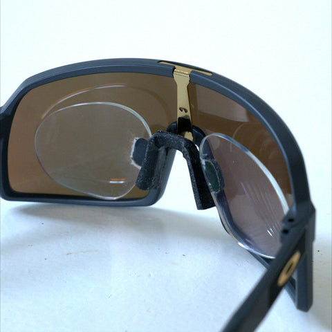 Angled rear view of Oakley Sutro S prescription clip insert clipped to nosepiece bracket