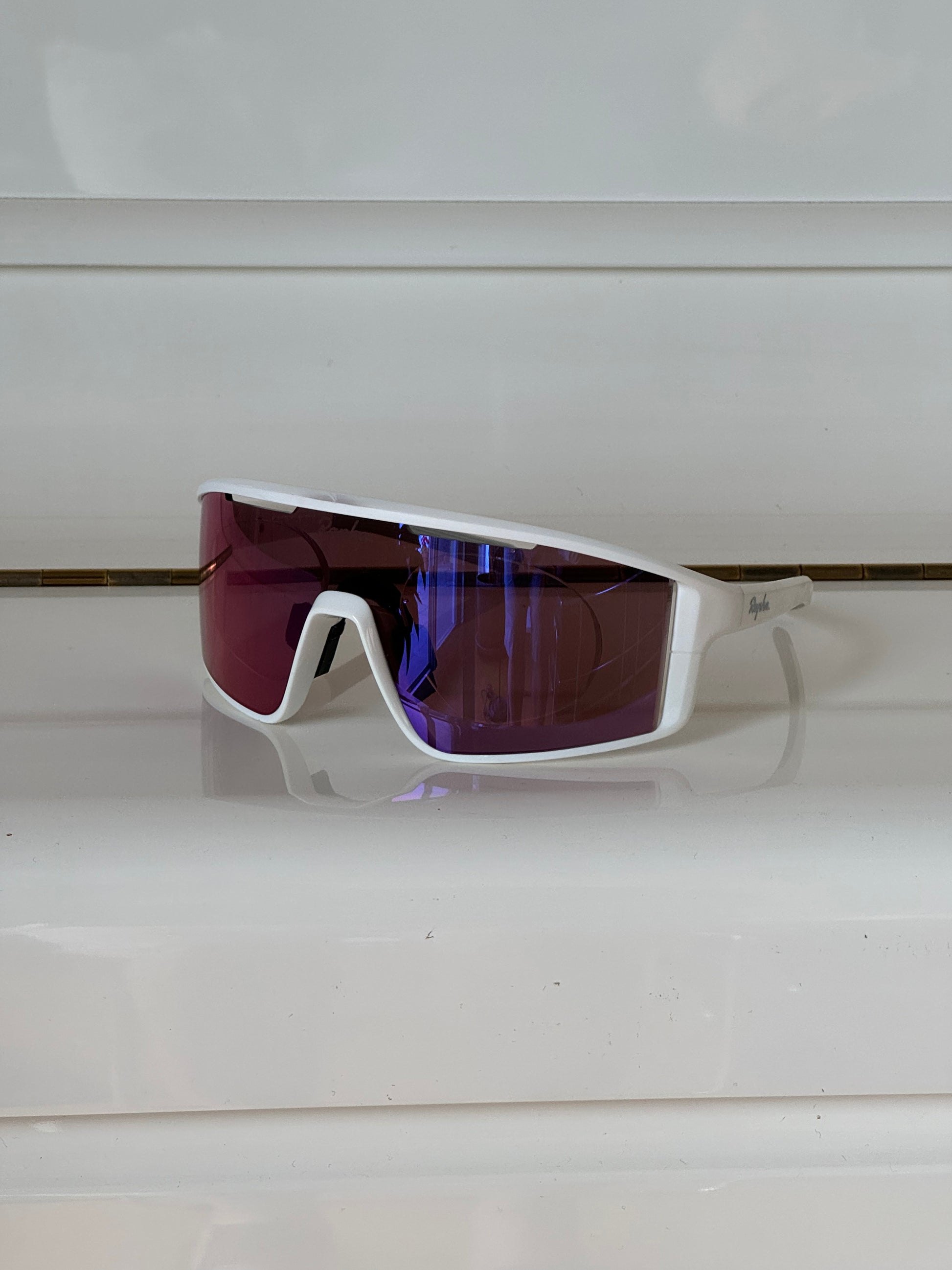 Cycling sunglasses with prescription insert installed, inside view showing pink lens