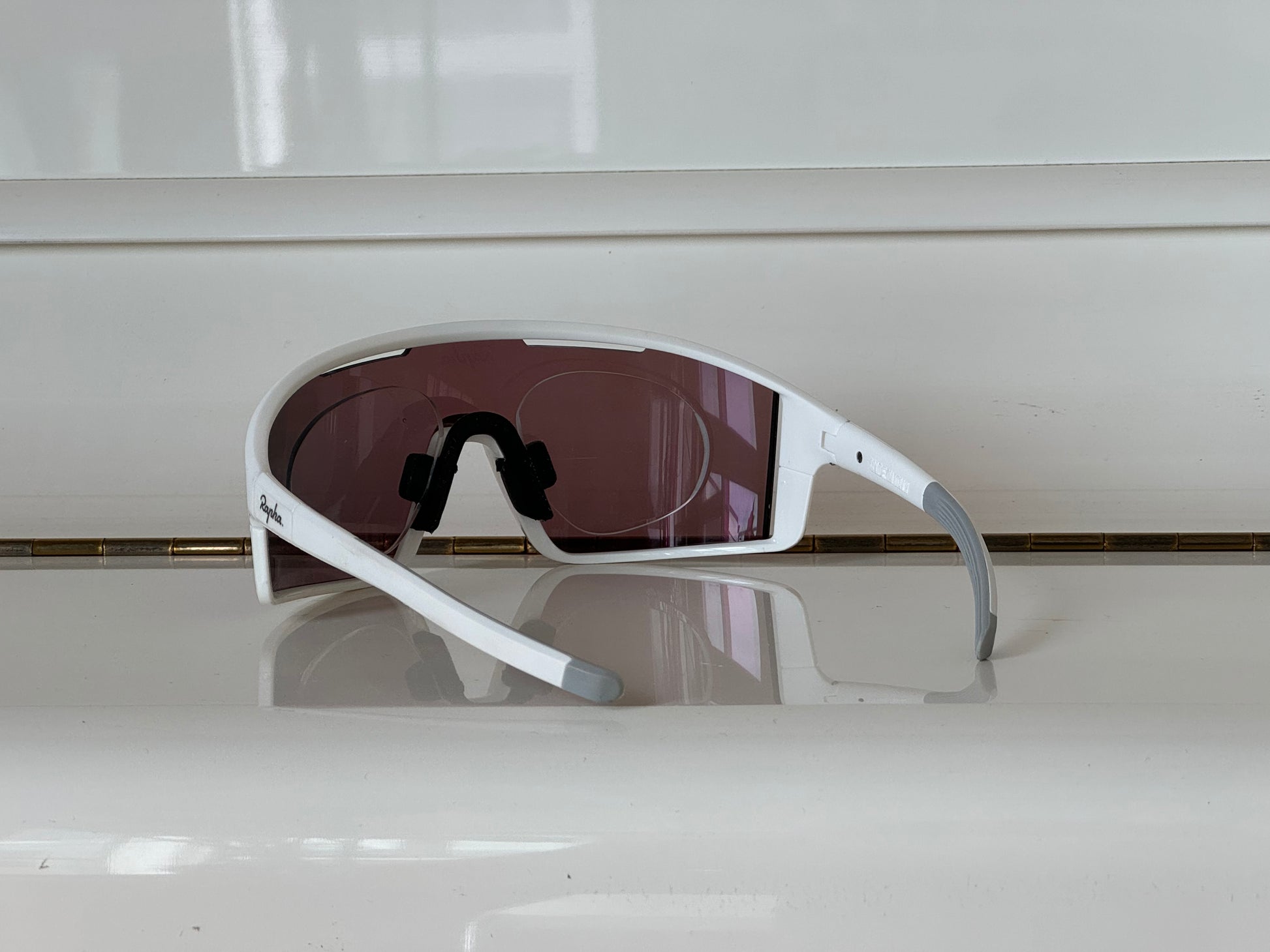Cycling sunglasses with prescription insert, white frame with purple-blue mirrored lens, side angle