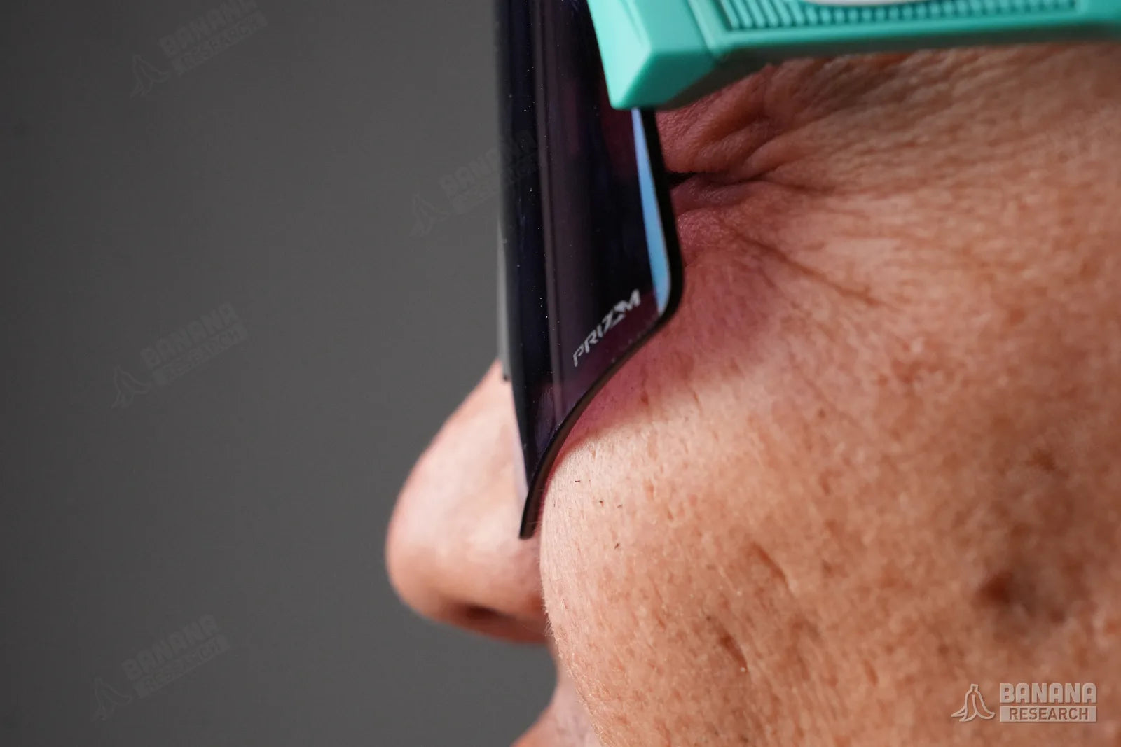 Worn, squinting, showing lens contact at the cheek