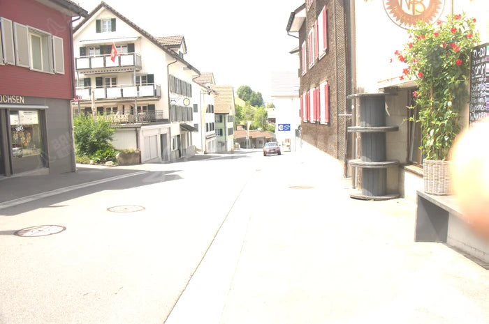 Town street at EV 10.6, seen through the Clear lens. Measured 100.0% of the clear control.